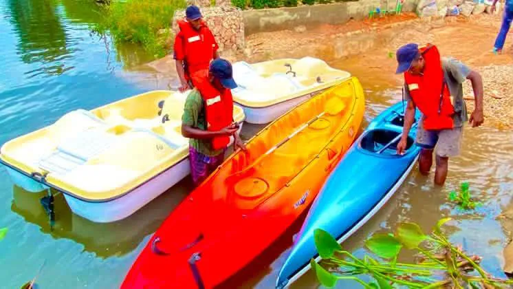 Resort guides launching kayaks and pedal boats on the river